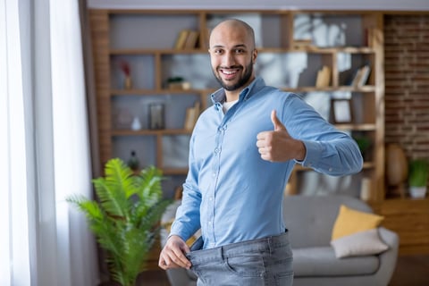 Happy man celebrating weight loss success